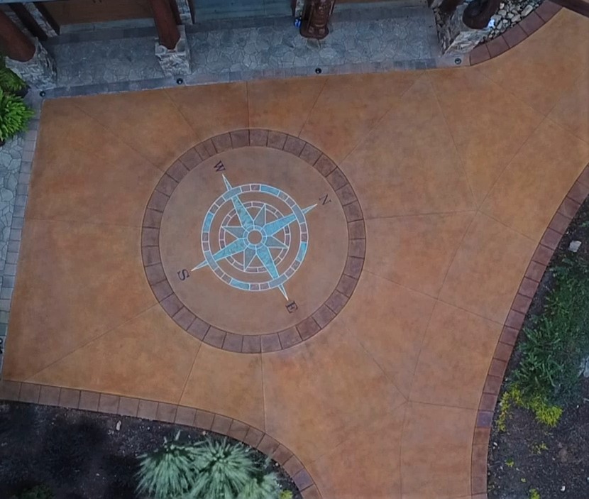 A large compass placed in the middle of a stained concrete driveway is the latest project for Ben Bass who has turned to the decorative side of concrete