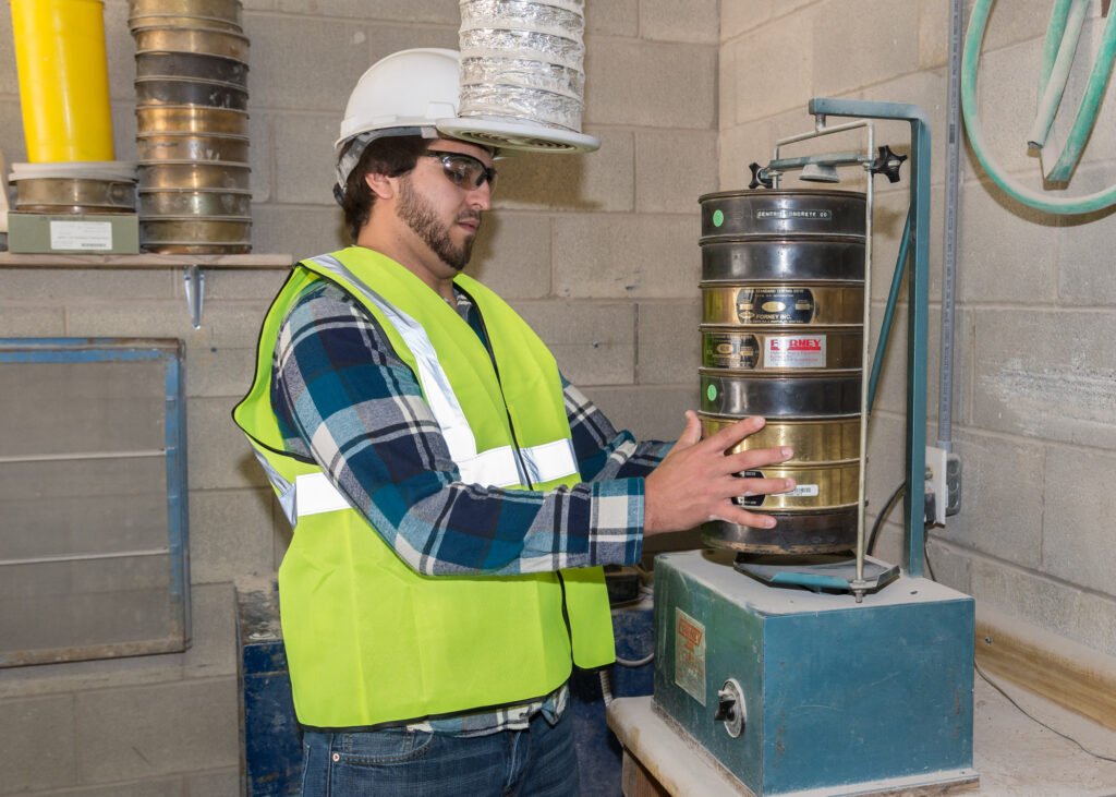 a student in a construction vest on the jobsite during his concrete science degree courses
