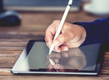 A person signing their digital signature on a tablet.