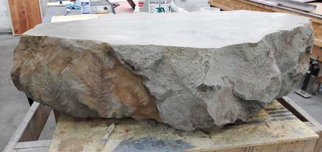 Carved coffee table in the shop getting its final touches.