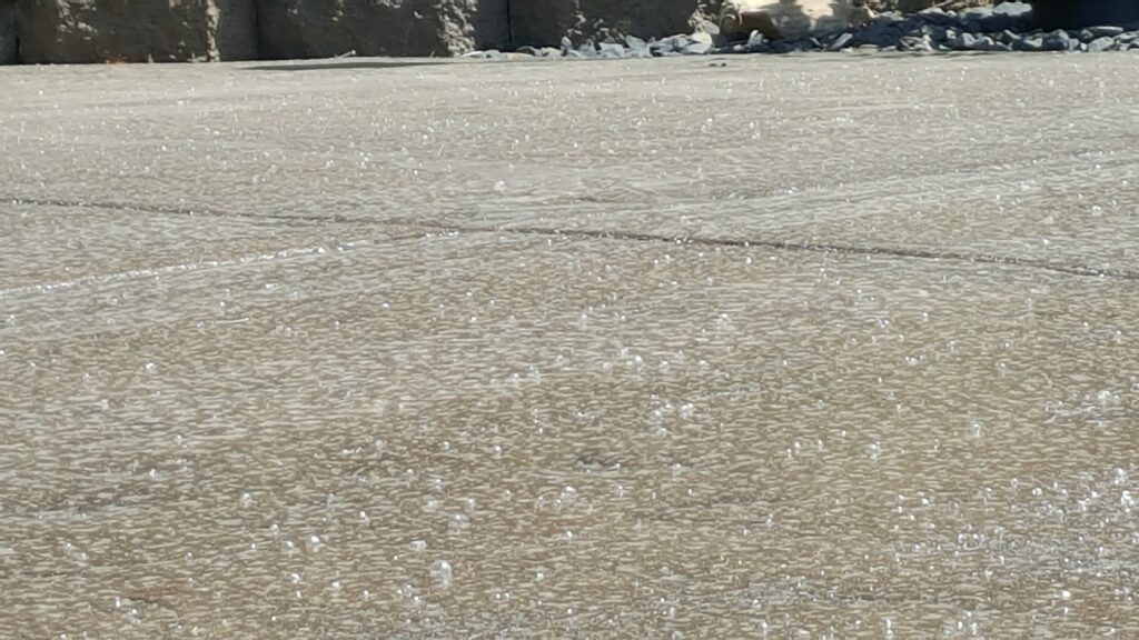 A slab of concrete with sealer on it.