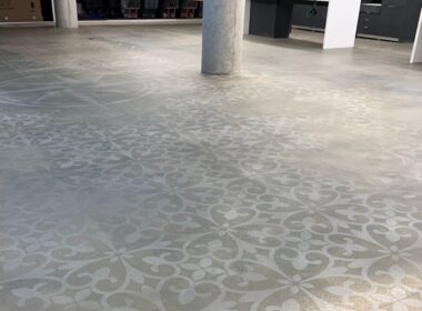 As part of an office renovation in downtown Chicago, the existing concrete floor was grinded, stenciled, stained and sealed. Part of the process involved manipulating the intensity of the stain and erasing parts of the stencil to create a worn look