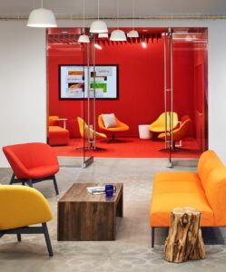 a modern office in reds and oranges with stenciled concrete in an office