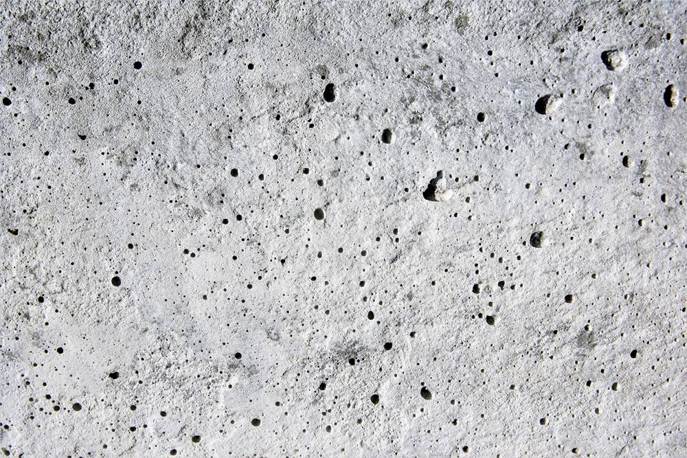 outgassing on a concrete surface causing pinhole effects in the concrete
