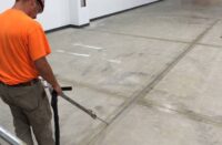 contractor installing joint filler to concrete control joints