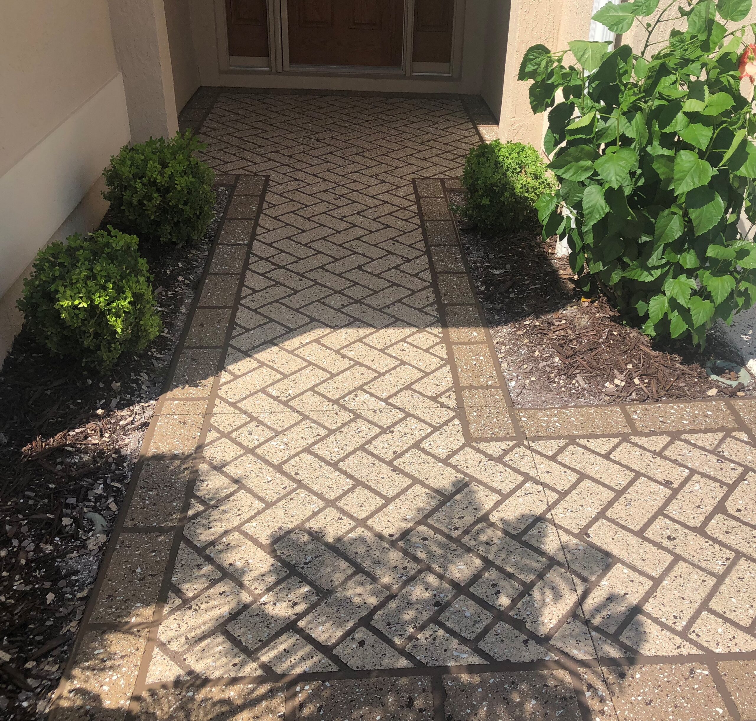 stenciled concrete walkway leading to a front door