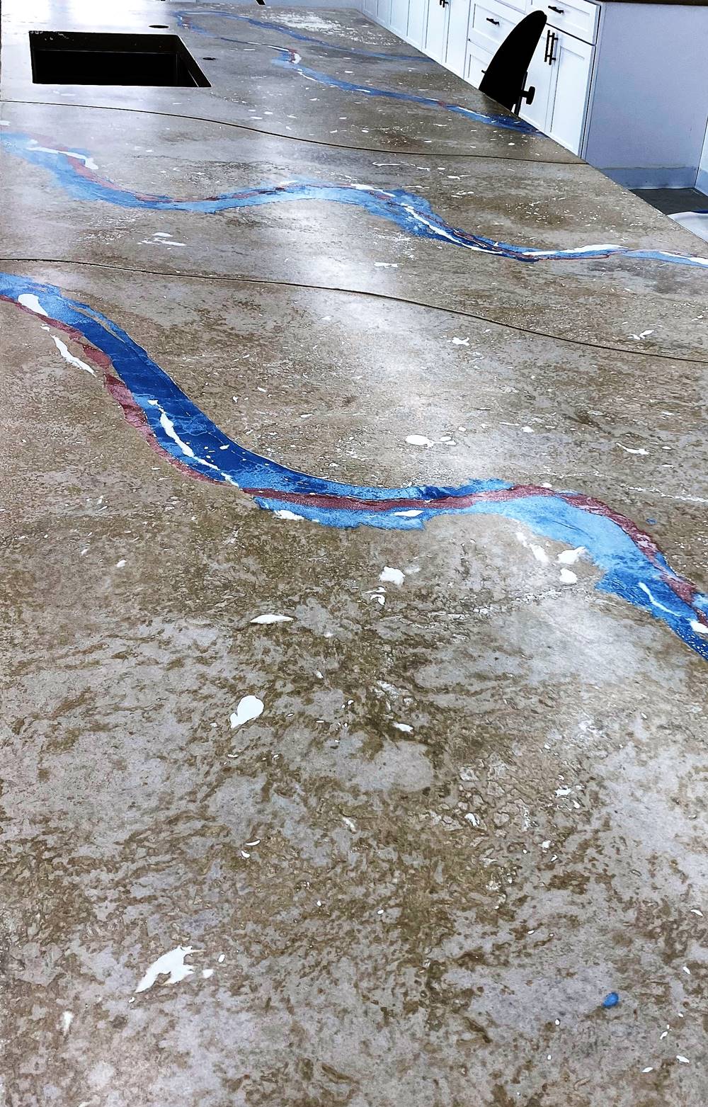 the seams of the concrete countertop are integrated into the design of the finished look