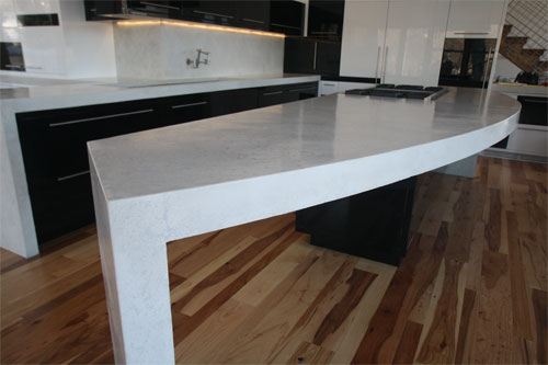 A white pressed concrete with a light grey infill was selected, and after samples were approved, the work began and spanned over two months. Several components were cast in our shop, and larger elements were cast in place, with the goal that they would all have the same finish.