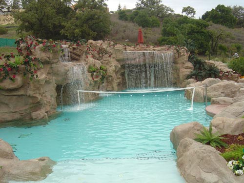 The project involved a recreation center with a pool and a waterfall, 40 feet high with 45,000 to 50,000 square feet of rock work. The pool is 200 feet long with 14-foot rock walls.