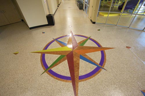 They installed Versatiles Roll On Rock System using 4195 Direct to Concrete Epoxy in Beige with a Saddletan flake and Clear Polyurea 5073 as the final topcoat