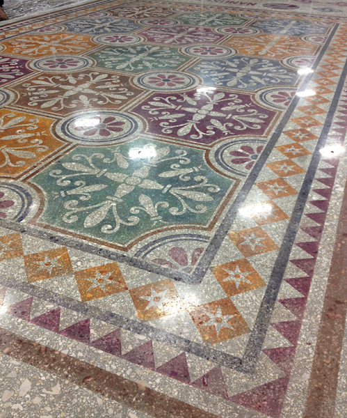 A concrete caropet of sorts created with stencils and alternating colors.