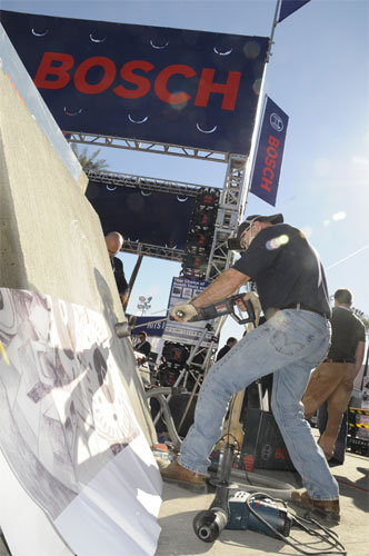 Gerald Taylor drills into the concrete to create the concrete mural.