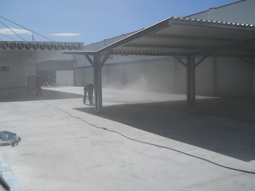 While the Epoxy 200 primer was still wet, four colors of chips - blue, orange, charcoal and green - were broadcast to the point of refusal into the primer, meaning all of the epoxy was completely covered with the flakes and no epoxy was showing. Prep
