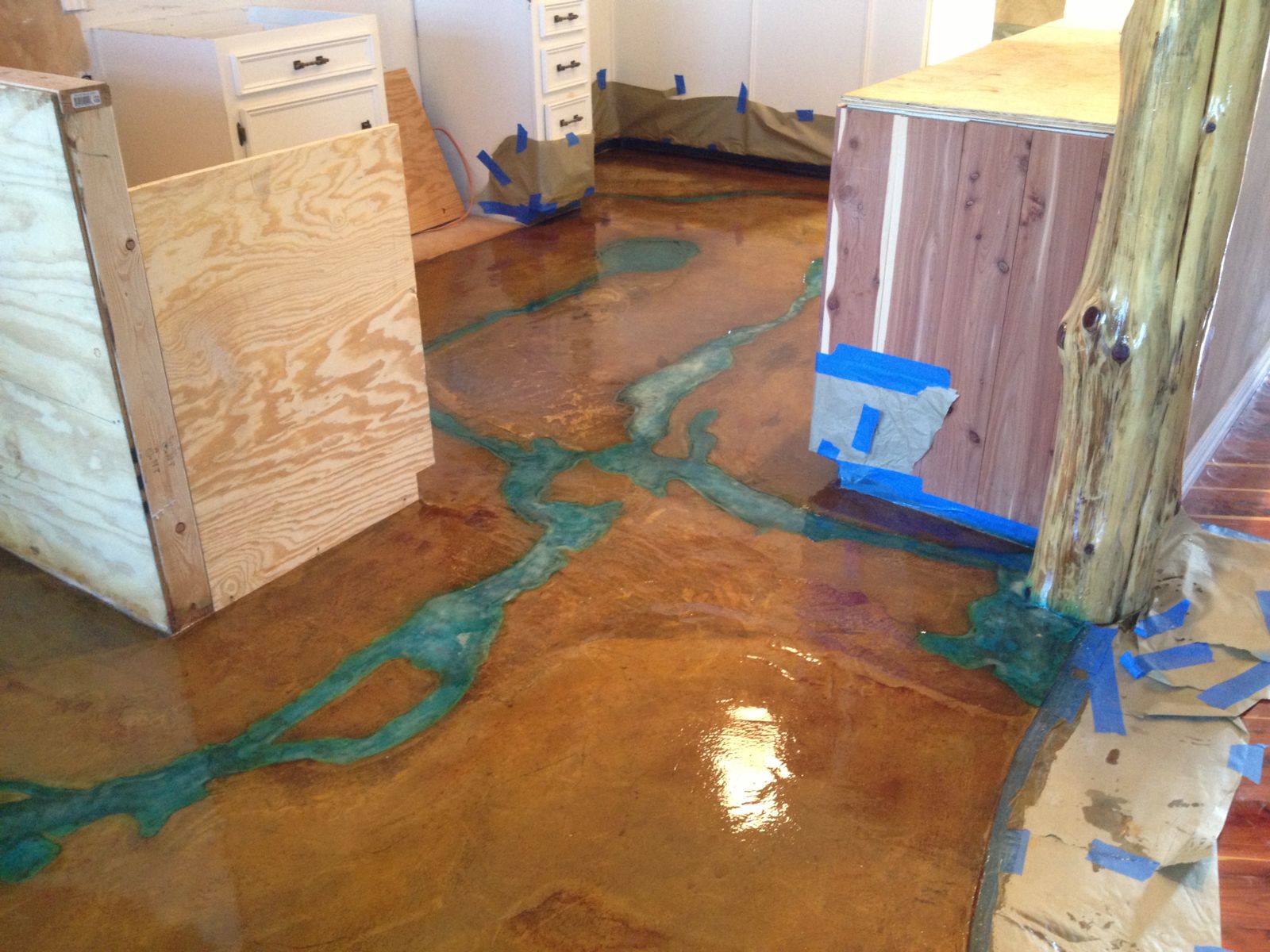 To compliment the river, Womack installed a piece he calls the raining tree. This piece utilized a raw cedar tree trunk running ceiling to floor that was then coated with a glow-in-the-dark (blue) pigment that cant be seen with the lights on or in day light; in a kitchen