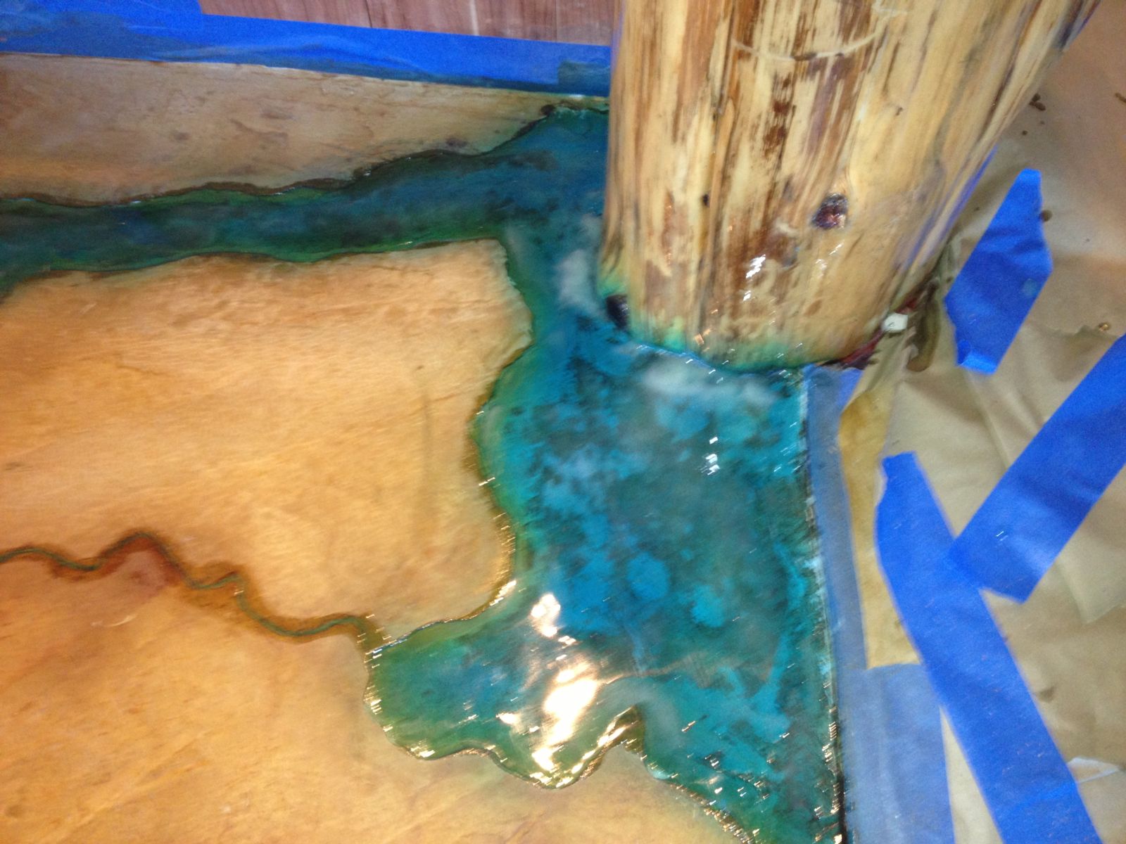 To compliment the river, Womack installed a piece he calls the raining tree. This piece utilized a raw cedar tree trunk running ceiling to floor that was then coated with a glow-in-the-dark (blue) pigment that cant be seen with the lights on or in day light; around a timber beam