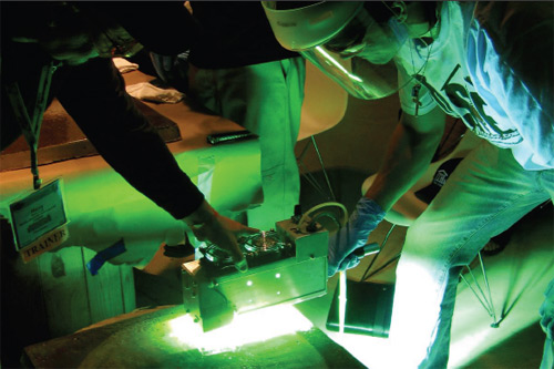 Harry Crum of Kemiko Decorative and Industrial Coatings demonstrates UV-curing equipment at the 2010 Concrete Decor Show & Decorative Concrete Spring Training. Crum clearly felt comfortable operating the equipment without gloves during the small-scale demo, but some experts advise against that. | Photo by John Strieder