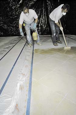 Staining Concrete with Personal Safety Gear, respirators and gloves. Needed on a concrete construction job site.