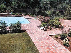 Aluminum Stamps from Lasting Impressions In Concrete used in a pool deck and side walk. Red stone look stamped concrete using aluminum stamp tools.