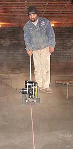 Man saw cutting concrete in a decorative design.