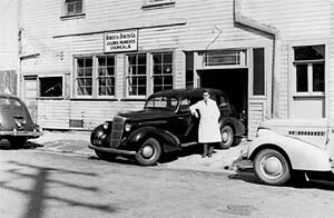 After arriving in the U.S. as a refugee from World War II, Frank Davis, who is standing next to an old car, became a partner in the Roberts-Davis Company in Los Angeles, a predecessor to the Davis Colors Company he founded in 1952.