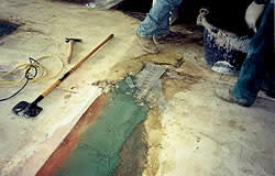 Between the line of terrazzo and carpet there was a high difference of 1" that had been filled with mortar. It came loose once they scarified the floor.