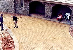 Stamping sand so that the customer can visualize what the drive will look like.This also gives inexperienced workers practice.