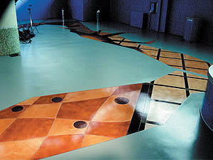 Mikhal Zambon floor design - mint green concrete overlay with geometric dots and strips using concrete stain.
