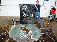 A stencil was used to transfer a CAD drawing to a concrete slab to be engraved and colored