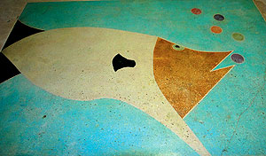 Combination of acid stains and dyes, laid out with specialty pin striping tape on white concrete.