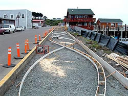 Bandon Boardwalk Construction - The two sides of the walkway were also doweled together, to keep one half from settling below the other over time. After both sides were finished, the entire concrete surface was coated with an acrylic sealer.
