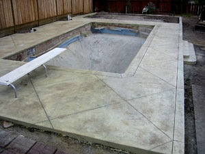 To make concrete less slippery, Ralston broadcasts a light mesh sand (100 grit or smaller) on the surface when applying sealer. "Another material that is effective and enhances the look of the deck is finely crushed glass," he says. "We prefer yellow glass because it has a subtle look, although when the sun shines on the glass there is a very beautiful sparkle that emanates from the deck." Photo courtesy of Tom Ralston Concrete