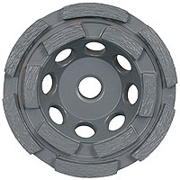 Two cup wheels sowing single-row and double-row arrangements of abrasive segments. Counterintuitively, the double row is less aggressive, because it is distributing the weight of the grinding machine over more surface area of abrasive, so each square inch of abrasive is applied with less downward pressure. The placement of gaps between the segments is critical to allow the wheel to clear dust or wet slurry.