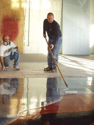 Bob Harris applying a sealer to a concrete floor.