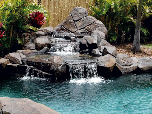 Concrete Waterfalls - This waterfall, from Rockmolds.com, was constructed using a stone and concrete substrate, waterproofed with a rolled-on rubber membrane, and finish-textured with hand-carving techniques and stamps from the company. Finally, it was acid-stained, neutralized, and sealed with an acrylic sealer.