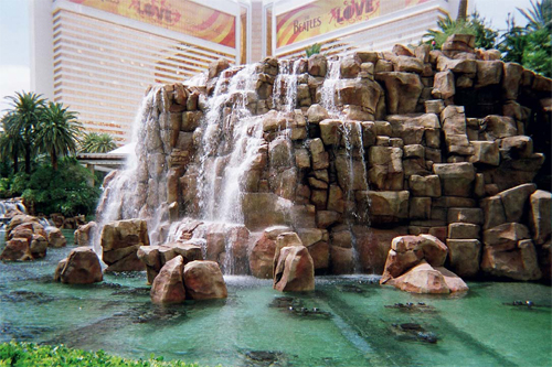 Concrete Waterfalls - A volcano at The Mirage Hotel and Casino in Las Vegas, Nev., from Rock and Waterscape incorporates sound, light, music and heat. Fireballs are sent more than 12 feet into the air, and water shoots 120 feet from the top of the volcanos center core. More than 85 artisans worked on this project, which involved more than 30,000 square feet of mesh and screen, more than 30 tons of structural steel, and 500 cubic yards of shotcrete.